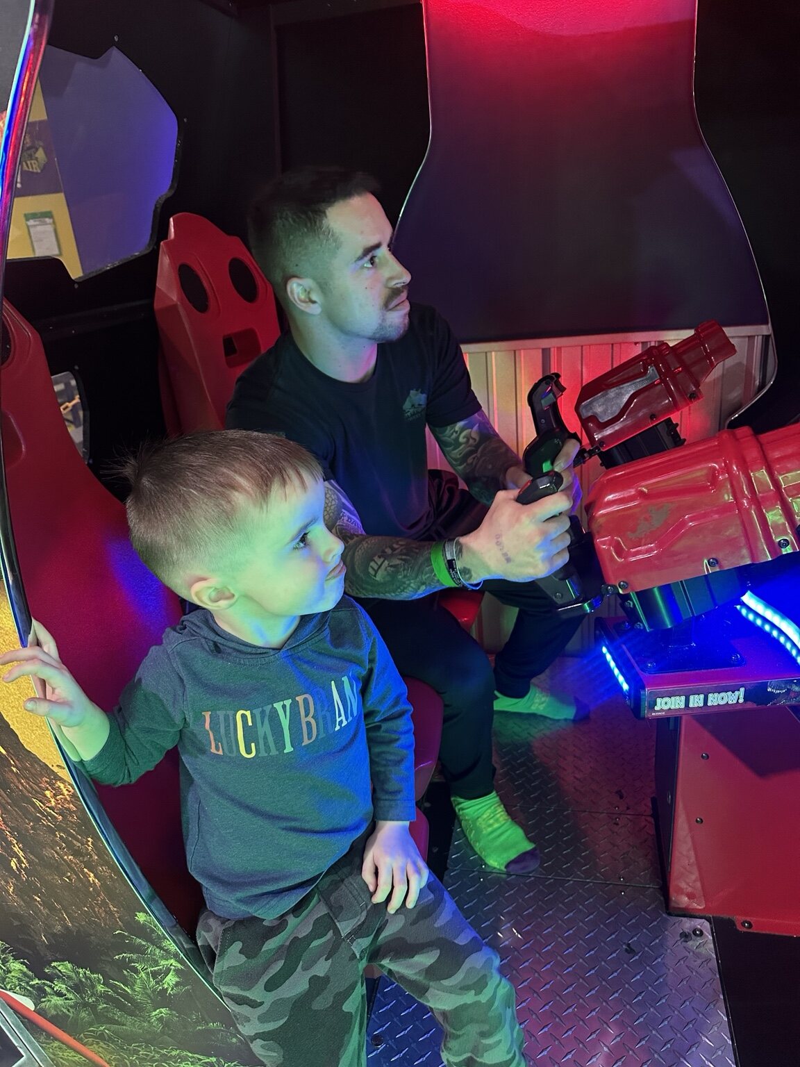 Johnny and Elliot playing an arcade game together